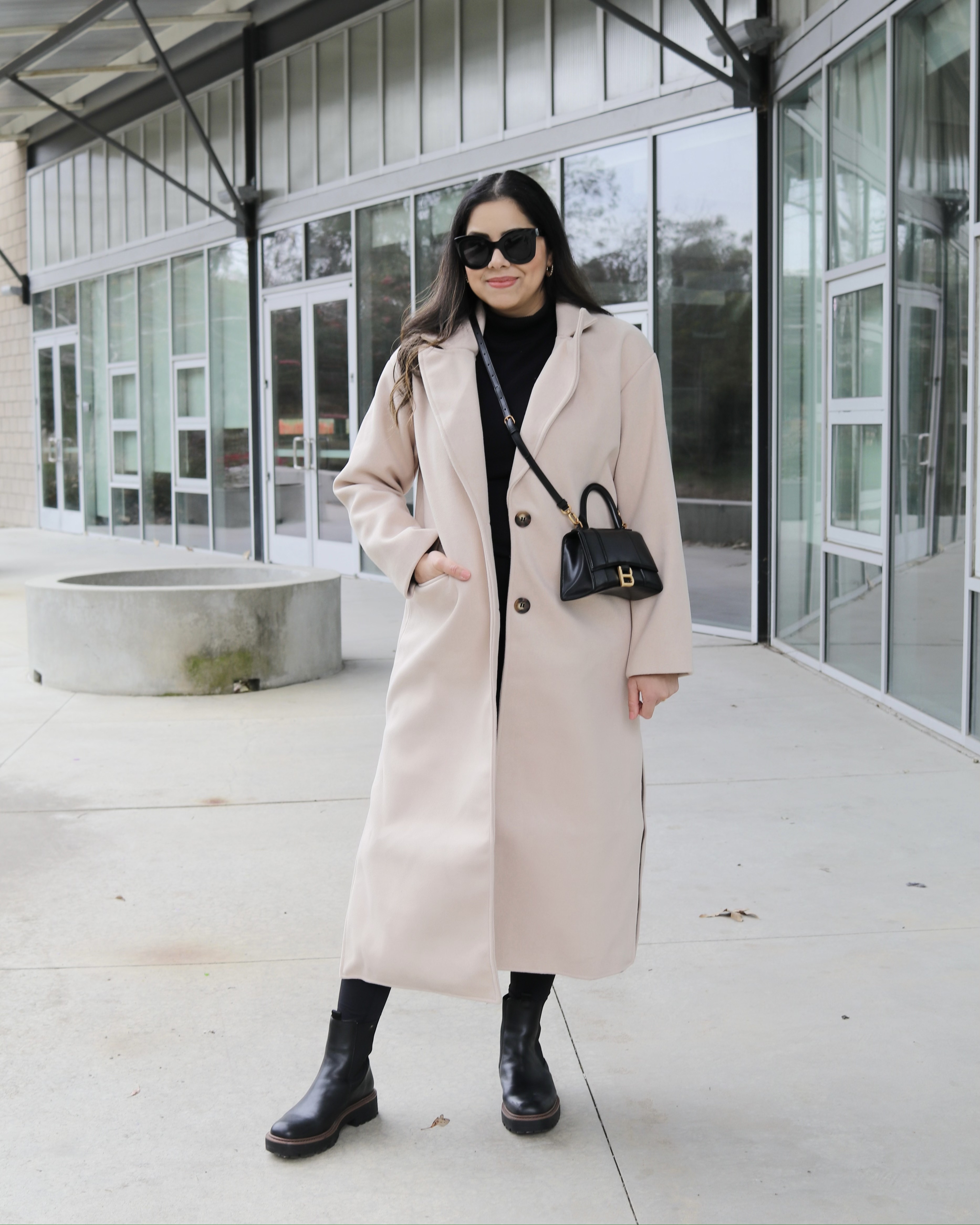 beige longline coat with black turtleneck outfit, black oversized sunnies