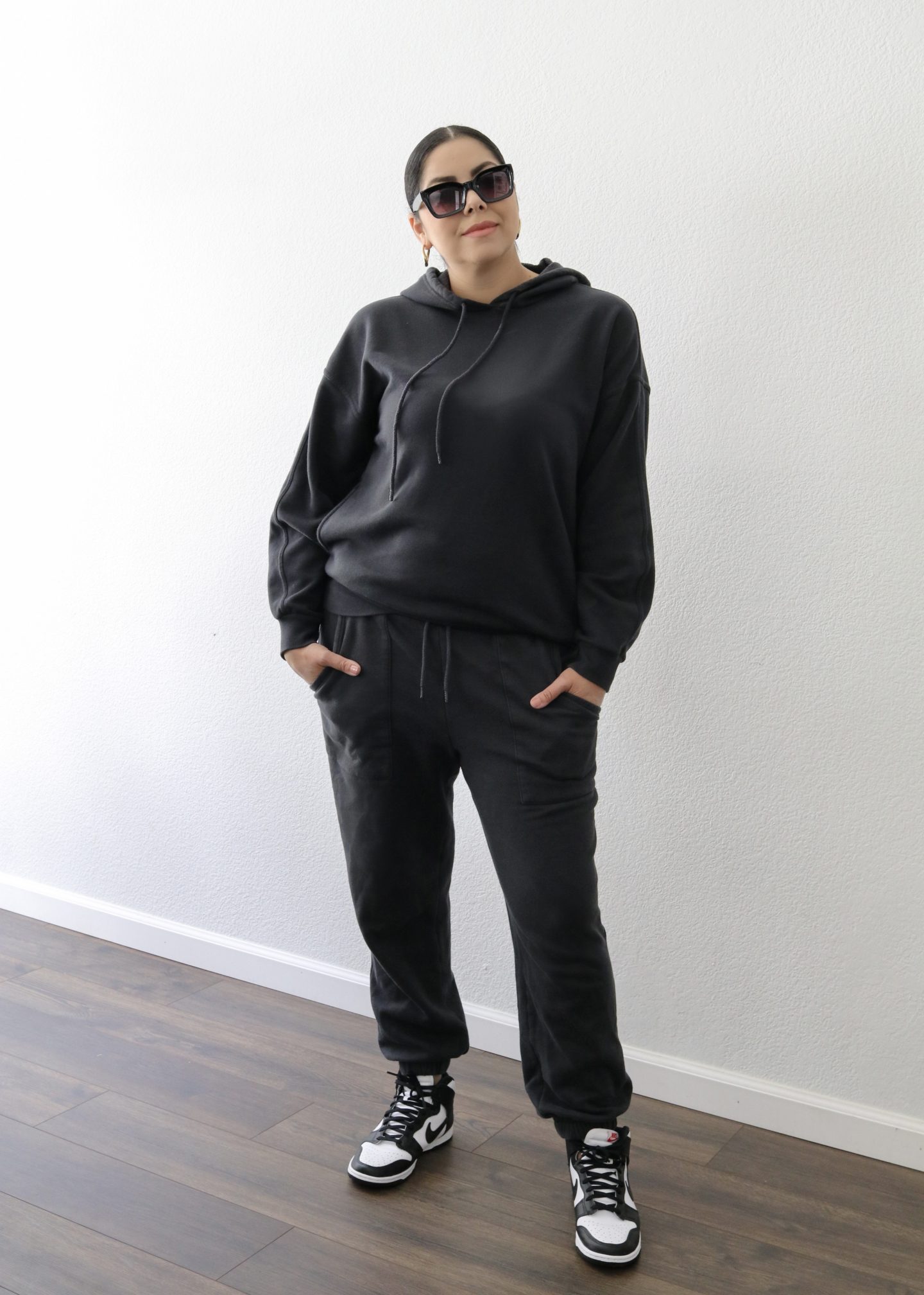 stylish mommy on the go in a black tracksuit, black sweatsuit and dunks high, casual streetwear for women