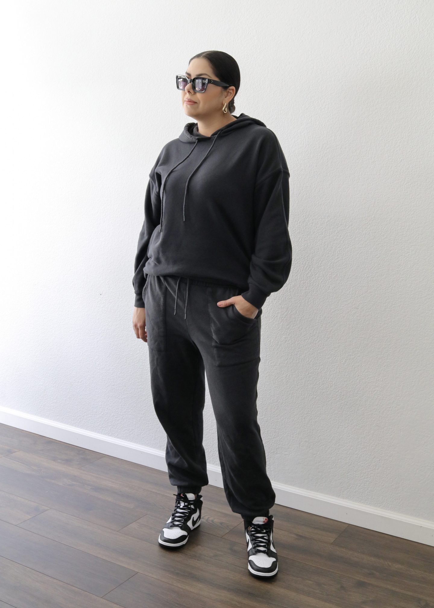 black hoodie with matching black sweatpants, black sweatpants with black and white dunks high, how to style dunks for women