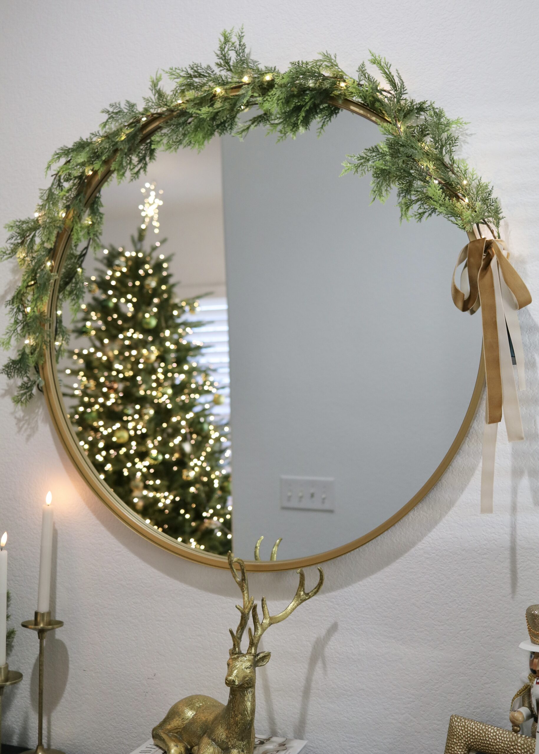 layered garlands on circle mirror, gold and warm lights Christmas decorations